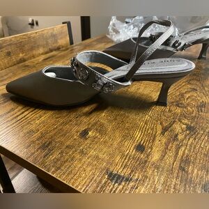 These are Anne Klein Iyana kitten heel pumps in a pewter color.